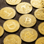 A high-definition, close-up view of various physical golden cryptocurrency coins—including Bitcoin, Ethereum, Dogecoin, and Litecoin—scattered across a dark, textured surface.